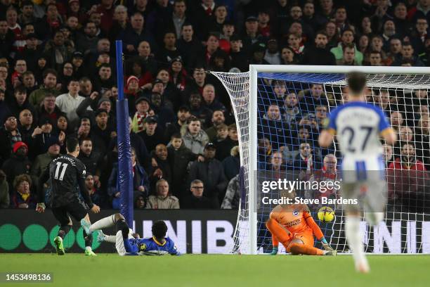 Gabriel Martinelli of Arsenal scores the team's fourth goal past Robert Sanchez of Brighton & Hove Albion during the Premier League match between...