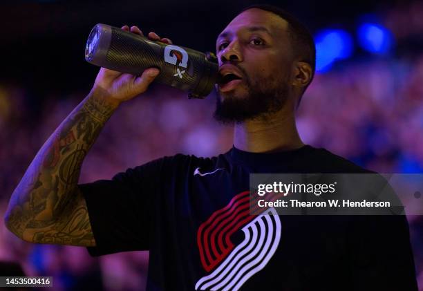 Damian Lillard of the Portland Trail Blazers taking a drink out of a gatorade bottle prior to the start of an NBA basketball game against the Golden...