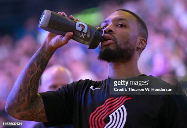 Damian Lillard of the Portland Trail Blazers taking a drink out of a gatorade bottle prior to the start of an NBA basketball game against the Golden...
