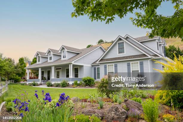 suburban home at sunset with lawn and garden visible - residential building outdoor stock pictures, royalty-free photos & images