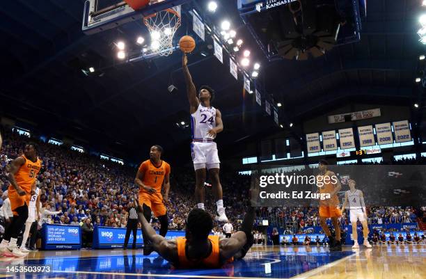 Adams Jr. #24 of the Kansas Jayhawks lays the ball up against the Oklahoma State Cowboys in the first half at Allen Fieldhouse on December 31, 2022...