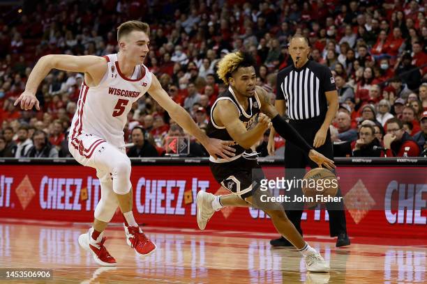 Lamar Norman Jr. #11 of the Western Michigan Broncos dribbles past Tyler Wahl of the Wisconsin Badgers during the first half at Kohl Center on...