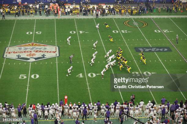 McCarthy of the Michigan Wolverines takes a snap during the first quarter against the TCU Horned Frogs in the Vrbo Fiesta Bowl at State Farm Stadium...