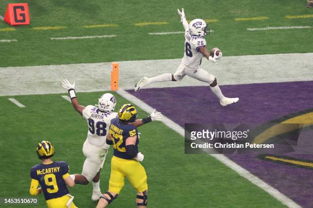 Bud Clark of the TCU Horned Frogs celebrates after returning an interception for a touchdown during the first quarter against the Michigan Wolverines...
