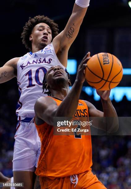 Chris Harris Jr. #2 of the Oklahoma State Cowboys lays the ball up against Jalen Wilson of the Kansas Jayhawks in the second half at Allen Fieldhouse...