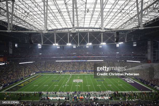 General view as the TCU Horned Frogs kick off to the Michigan Wolverines during the first quarter in the Vrbo Fiesta Bowl at State Farm Stadium on...