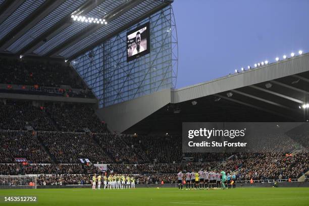 Bruno Guimaraes wears a signed Pele 10 shirt, as the teams hold to a minutes applause in memory of former Brazil player Pele prior to the Premier...