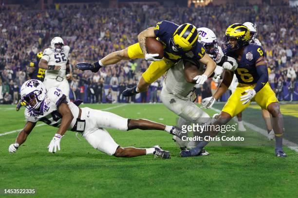Roman Wilson of the Michigan Wolverines dives for the end zone to score a touchdown during the fourth quarter against the TCU Horned Frogs in the...