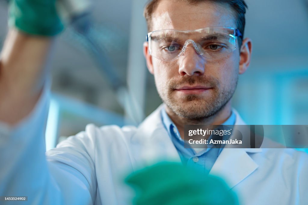 Portrait Of A Scientist Using A Pipette for Filling Test Tube