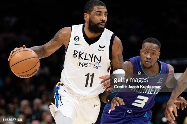Kyrie Irving of the Brooklyn Nets brings the ball up court past Terry Rozier of the Charlotte Hornets in the first quarter during their game at...