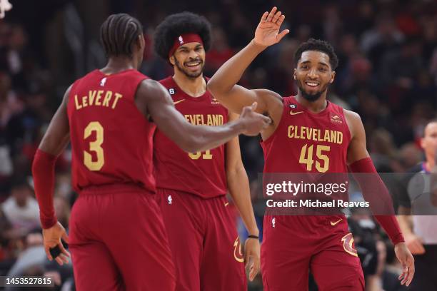 Caris LeVert and Donovan Mitchell of the Cleveland Cavaliers high five against the Chicago Bulls during the first half at United Center on December...