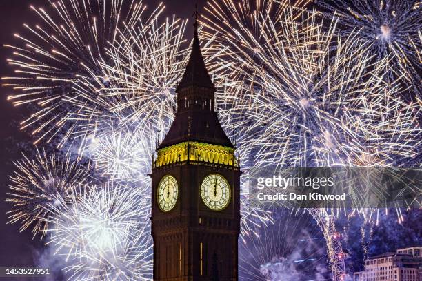 Fireworks light up the London skyline over Big Ben and the London Eye just after midnight on January 1, 2023 in London, England. London's New Years'...