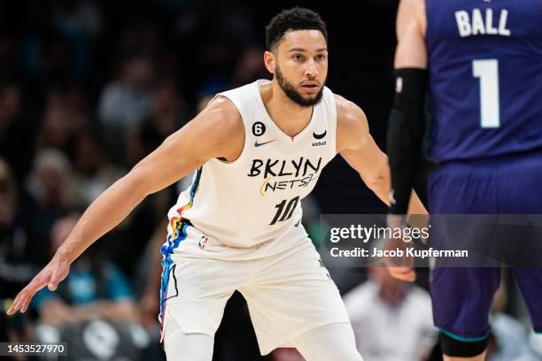 Ben Simmons of the Brooklyn Nets guards LaMelo Ball of the Charlotte Hornets in the second quarter during their game at Spectrum Center on December...