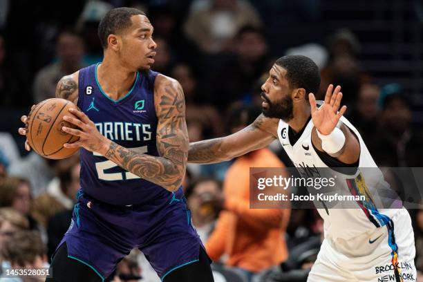 Kyrie Irving of the Brooklyn Nets guards P.J. Washington of the Charlotte Hornets in the second quarter during their game at Spectrum Center on...