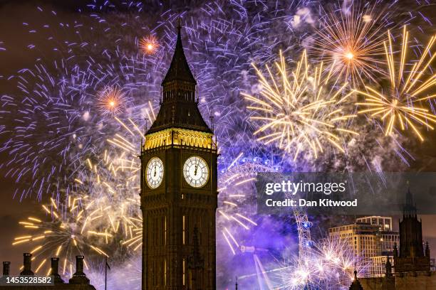 Fireworks light up the London skyline over Big Ben and the London Eye just after midnight on January 1, 2023 in London, England. London's New Years'...