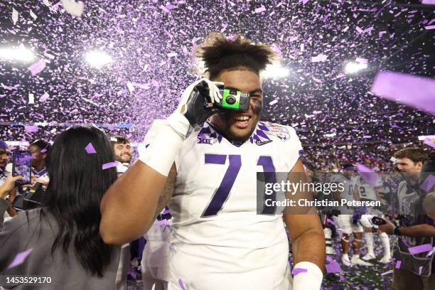 The TCU Horned Frogs celebrate after defeating the Michigan Wolverines in the Vrbo Fiesta Bowl at State Farm Stadium on December 31, 2022 in...