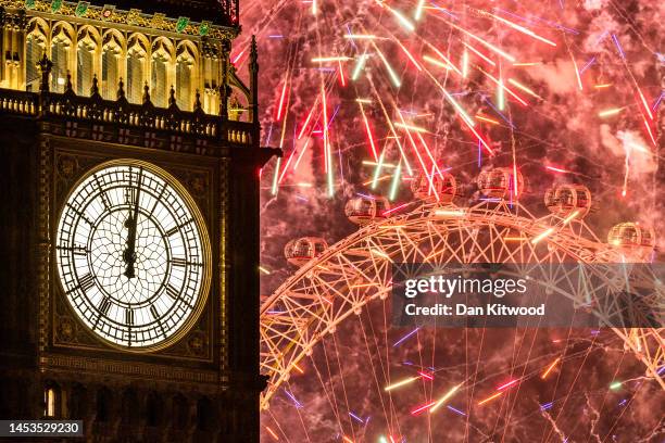 Fireworks light up the London skyline over Big Ben and the London Eye just after midnight on January 1, 2023 in London, England. London's New Years'...