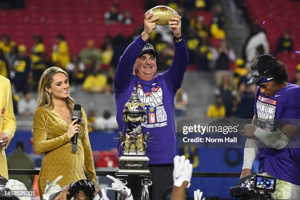 Head coach Sonny Dykes of the TCU Horned Frogs celebrates with the trophy after defeating the Michigan Wolverines in the Vrbo Fiesta Bowl at State...