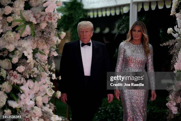 Former U.S. President Donald Trump and former first lady Melania Trump arrive for a New Years event at his Mar-a-Lago home on December 31, 2022 in...