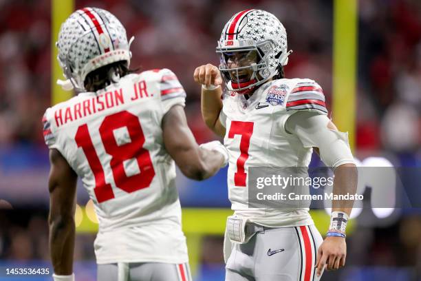 Marvin Harrison Jr. #18 of the Ohio State Buckeyes celebrates with teammates after a touchdown during the second quarter in the Chick-fil-A Peach...