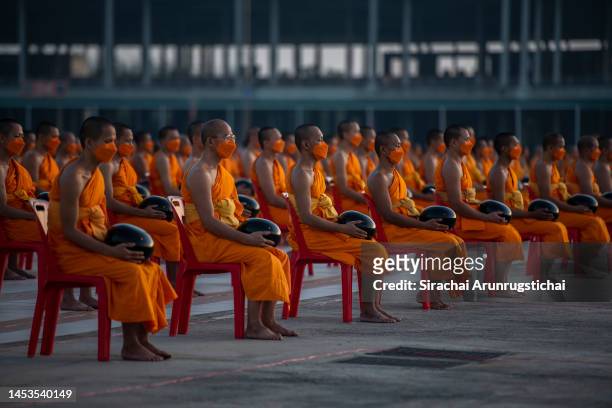 Buddhist monks meditate during the mass alms giving ceremony for New Year where 3,000 monks attend at Wat Phra Dhammakaya Buddhist Temple on January...
