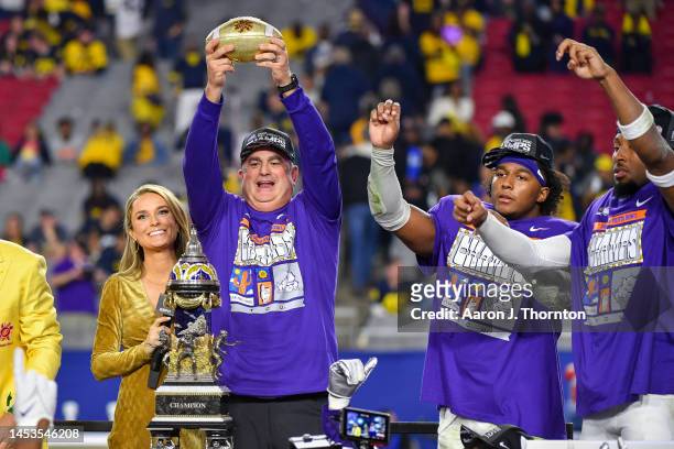 Head Football Coach Sonny Dykes, Dee Winters, and Quinton Johnston of the TCU Horned Frogs celebrate with the trophy after winning the Vrbo Fiesta...
