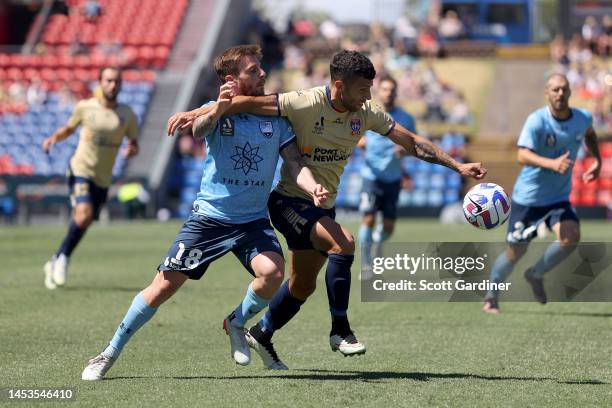 Diego Alonso of Sydney FC and Jashua Sortirio of the Jets competes for the ball with during the round 10 A-League Men's match between Newcastle Jets...