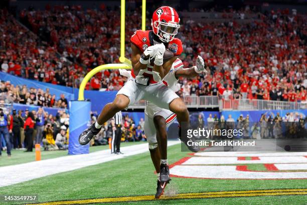 Adonai Mitchell of the Georgia Bulldogs catches a touchdown pass during the fourth quarter against the Ohio State Buckeyes in the Chick-fil-A Peach...