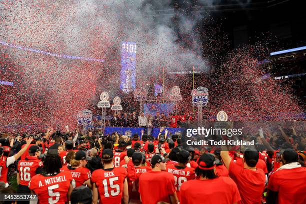 Head coach Kirby Smart of the Georgia Bulldogs celebrates with the trophy after defeating the Ohio State Buckeyes in the Chick-fil-A Peach Bowl at...