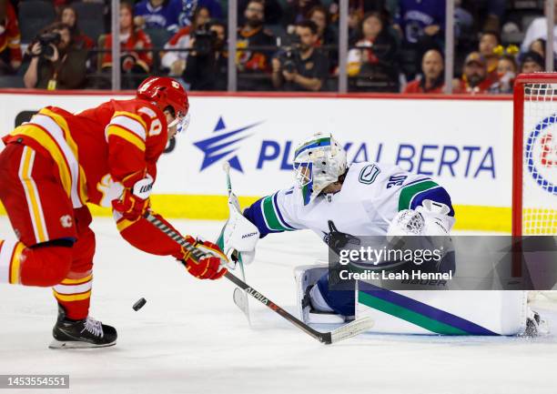 Blake Coleman of the Calgary Flames takes a shot on Spencer Martin of the Vancouver Canucks in the third period at the Scotiabank Saddledome on...