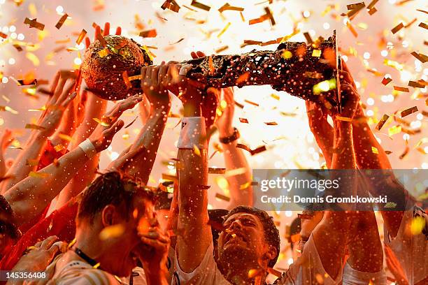 Marcus Ahlm of Kiel lifts the trophy after the EHF Final Four final match between THW Kiel and BM Atletico Madrid at Lanxess Arena on May 27, 2012 in...