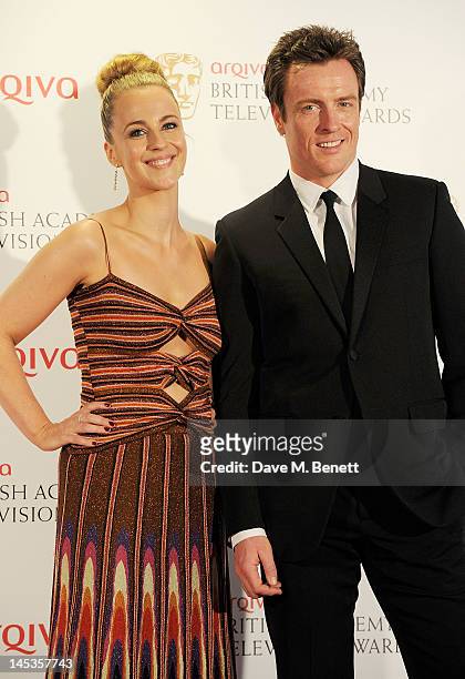 Presenters Miranda Raison and Toby Stephens pose in front of the winners boards at the Arqiva British Academy Television Awards 2012 held at Royal...