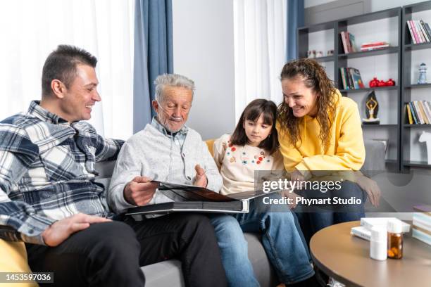 family with  photo album at home - breathing device stock pictures, royalty-free photos & images