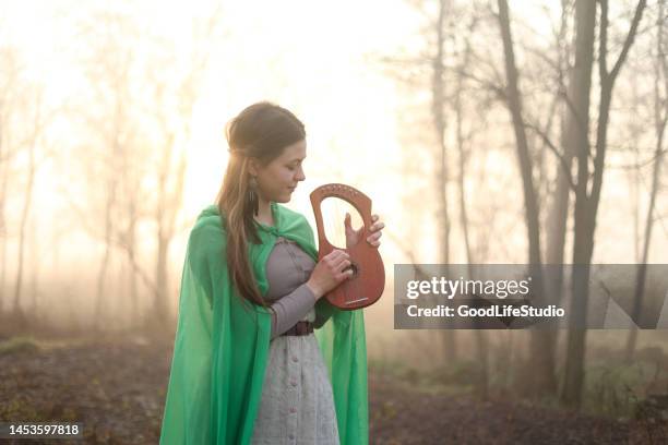 young woman playing a lyra - lyre stock pictures, royalty-free photos & images