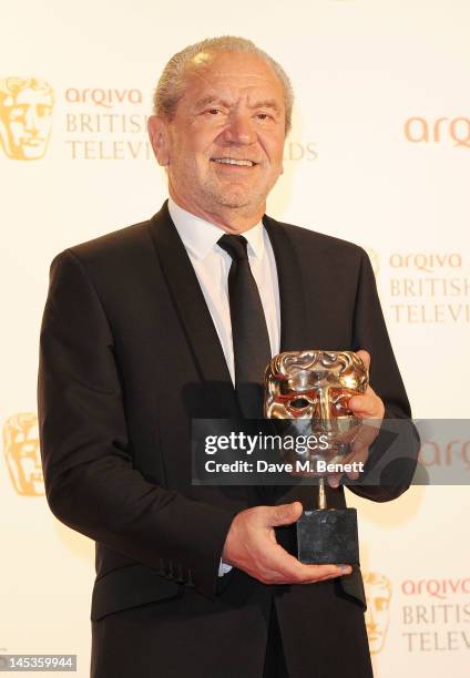 Winner of Best Reality and Constructed Factual for 'The Young Apprentice' Lord Alan Sugar poses in front of the winners boards at the Arqiva British...