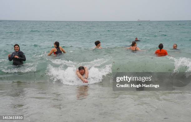 Swimmers take part in the traditional New Year's Day sea swim in the English Channel at Gyllyngvase Beach on January 01, 2023 in Falmouth, Cornwall,...