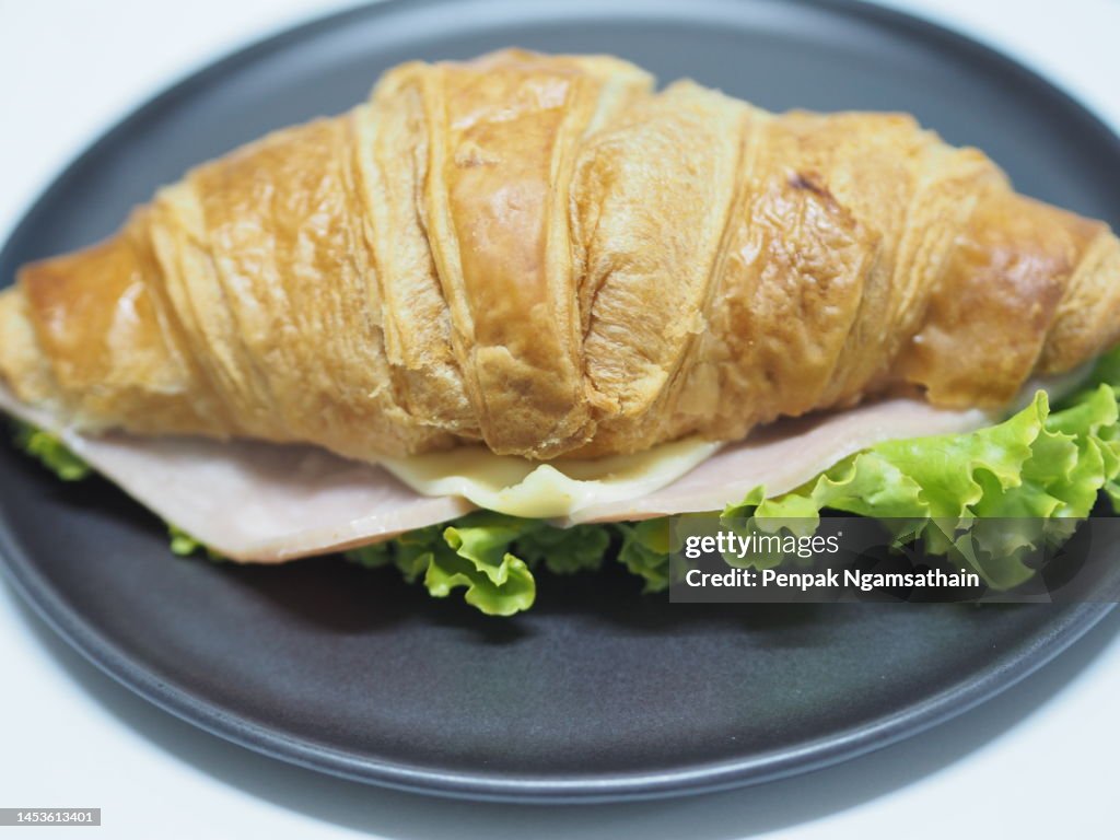 Ham Cheese Croissant on black plate