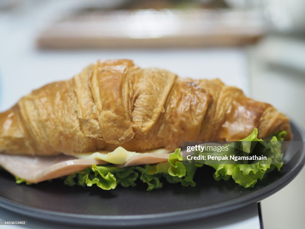 Ham Cheese Croissant on black plate