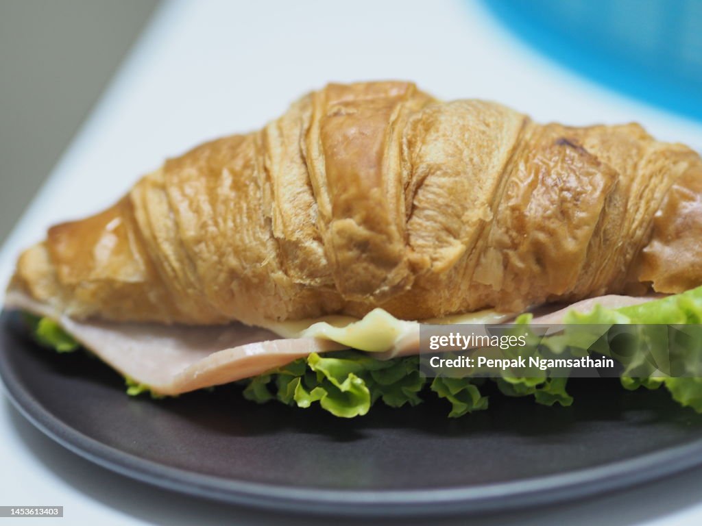 Ham Cheese Croissant on black plate