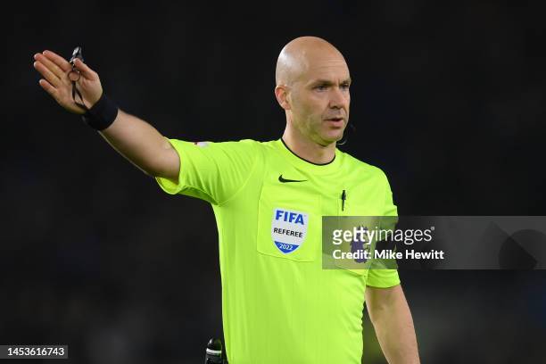 Referee Anthony Taylor signals during the Premier League match between Brighton & Hove Albion and Arsenal FC at American Express Community Stadium on...