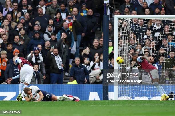 Harry Kane of Tottenham Hotspur has a shot blocked by Ashley Young of Aston Villa during the Premier League match between Tottenham Hotspur and Aston...