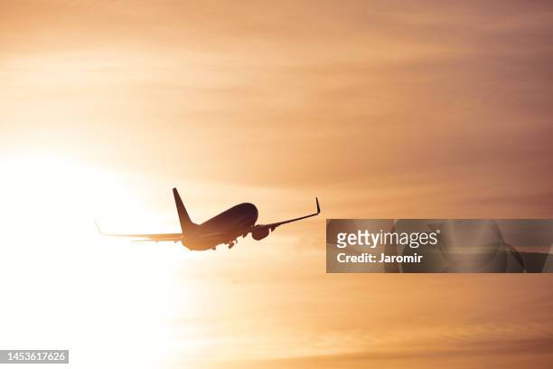 silhouette of airplane after take off - beauty launch stock pictures, royalty-free photos & images
