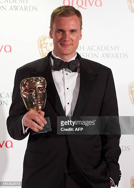 Winner of Male performance in a comedy Darren Boyle for the show Spy poses in front of the winners boards at the British Academy Television Awards at...