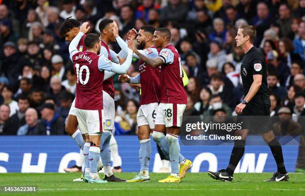 Douglas Luiz of Aston Villa celebrates with team mates after scoring their sides second goal during the Premier League match between Tottenham...