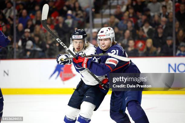 Luke Mittelstadt of Team USA checks Ville Koivunen of Team Finland in front of USA net during first period during the 2023 IIHF World Junior...