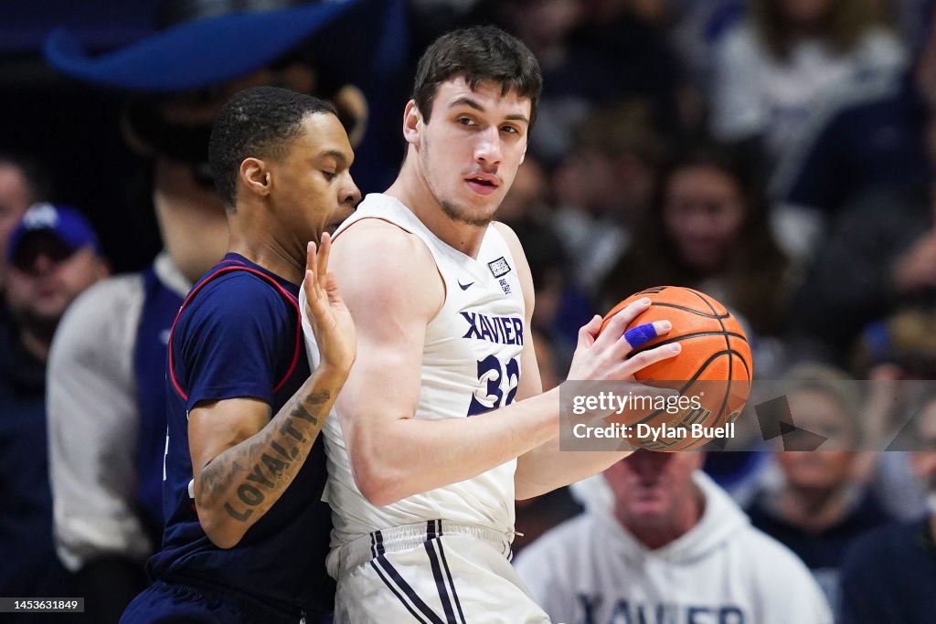 Zach Freemantle of the Xavier Musketeers handles the ball while being ...