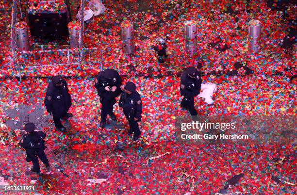 Police officers stand on a confetti filled street after celebrations on New Year's Eve in Times Square on January 1 in New York City.