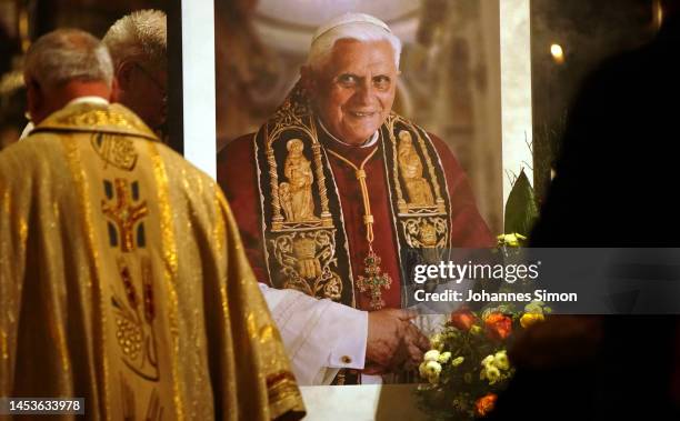 Portrait of the late Pope Emeritus Benedict XVI is displayed in front of the altarpiece of the central catholic pilgrimage church during a festive...