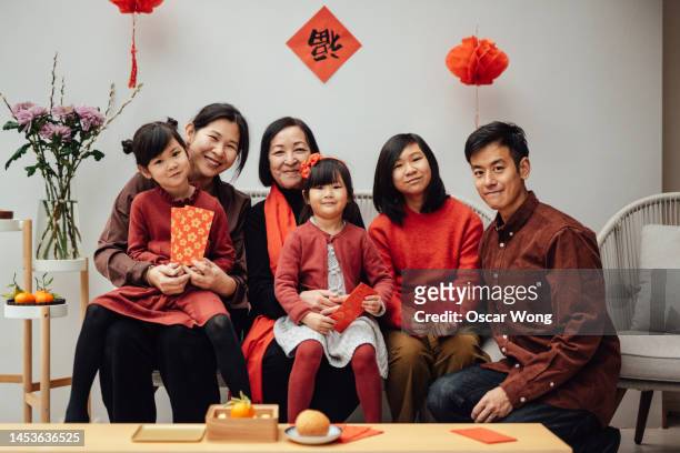 cheerful three-generation asian family portrait for chinese new year - fashionable grandma stock pictures, royalty-free photos & images