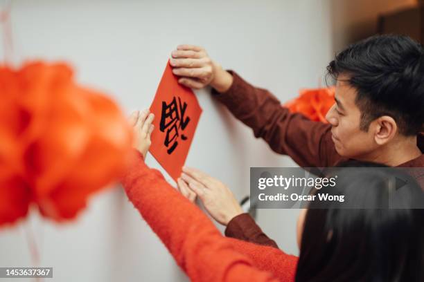 family preparing for chinese new year - cap go meh ストックフォトと画像